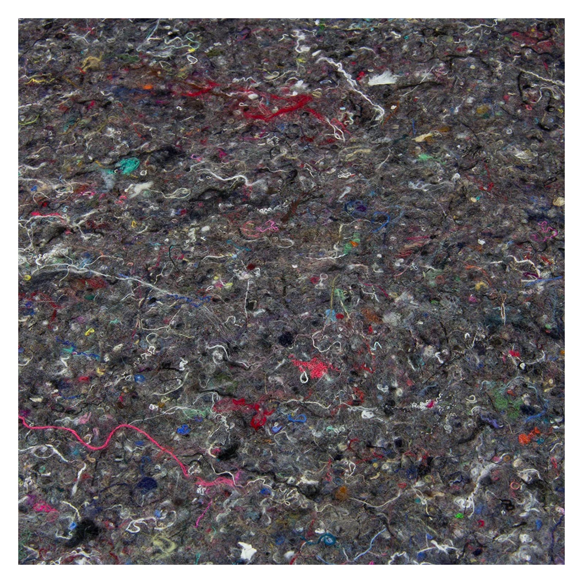 Eine Nahaufnahme der Hard Head Painting Matte zeigt ihre dicke, filzartige Textur mit grauen Fasern, kombiniert mit roten, blauen und rosa Fäden, was ein einzigartig geflecktes und strukturiertes Aussehen erzeugt.