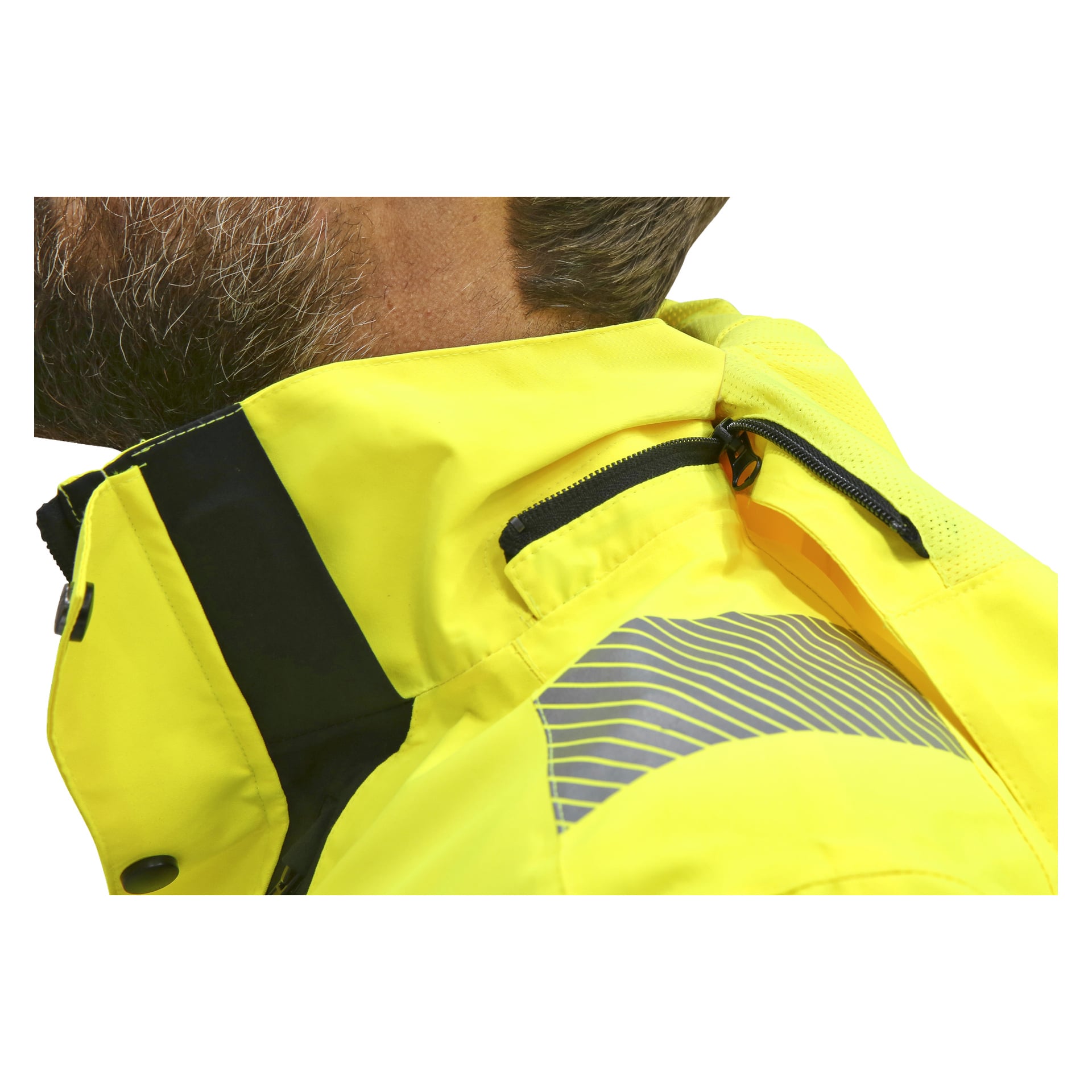 En närbild visar någon som bär Bluewear Hi-Vis-jackan, som är klargul med reflekterande ränder och har en svart dragkedja vid kragen. Personens nedre ansikte och hals kan ses.