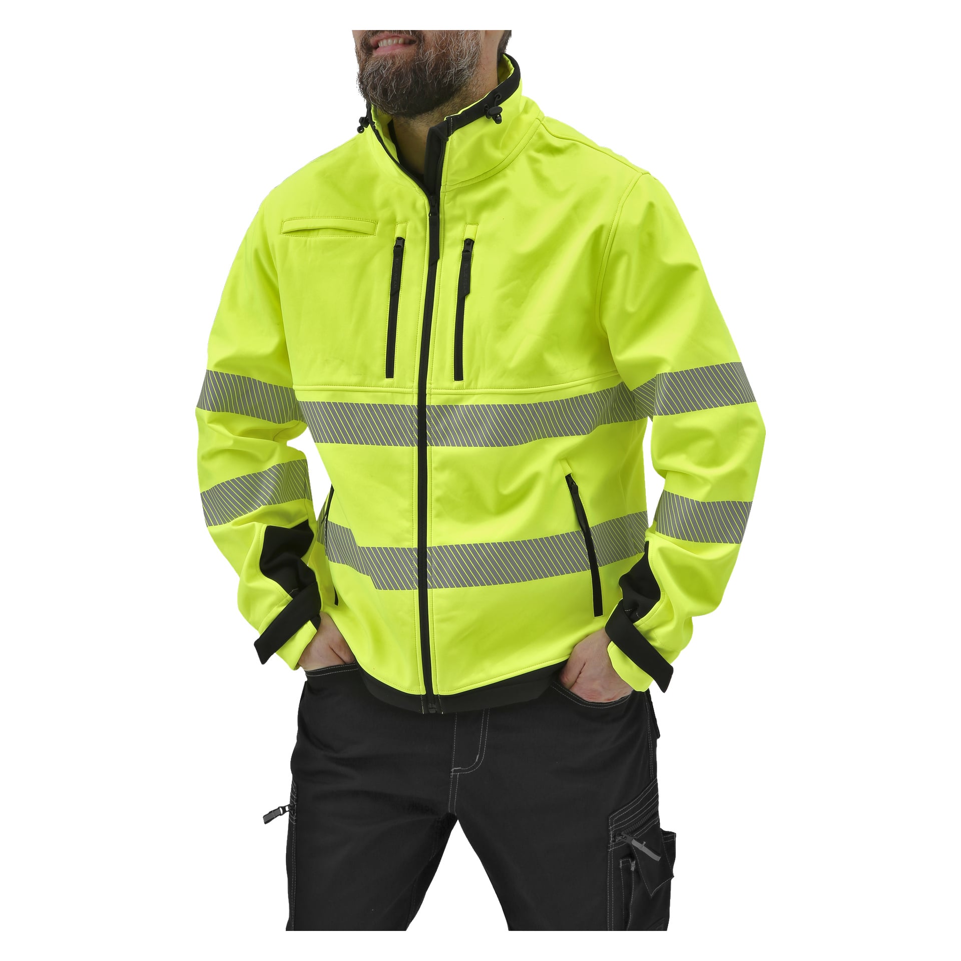 En skäggig man bär Bluewear Hi-Vis softshelljacka Toronto, som är gjord av klargult högsynligt tyg, har reflekterande ränder och svarta dragkedjor. Han har händerna i fickorna och har mörka byxor på sig.