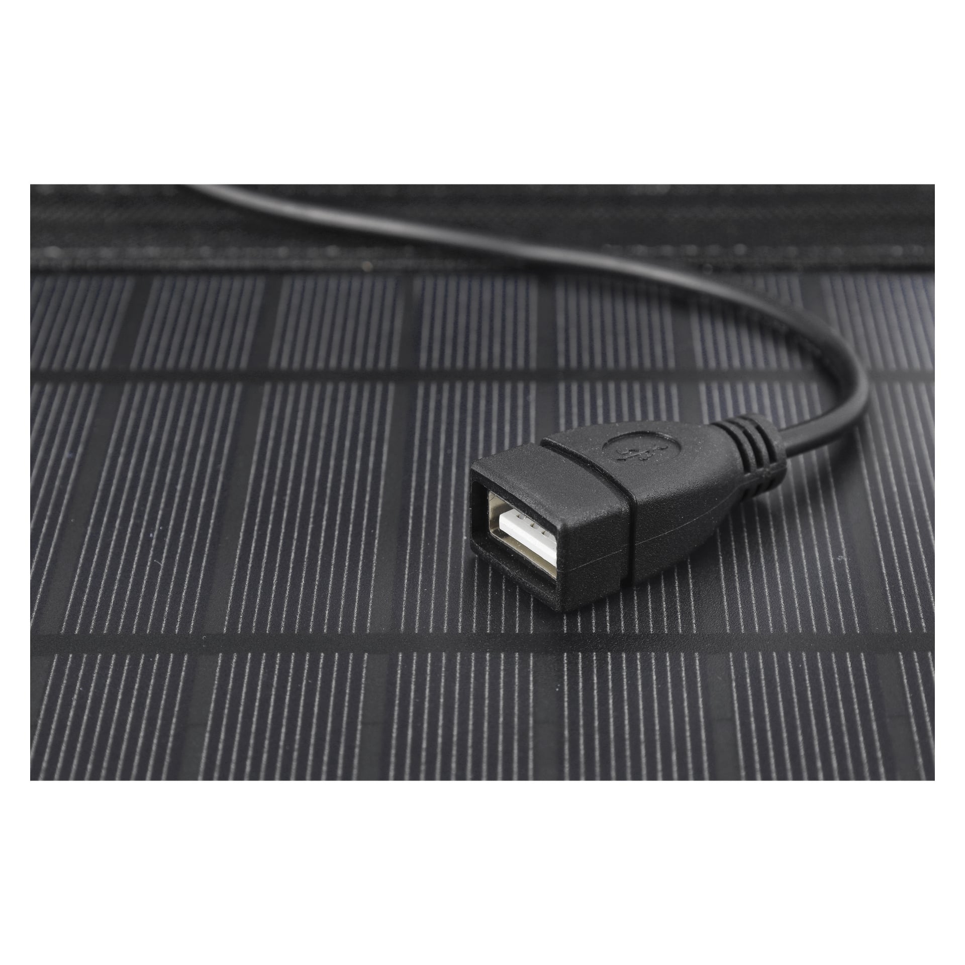 En USB-A honkabels kontaktkabel från Kayoba Outdoor Foldable Solar Cell Charger ligger på en yta med tunna, parallella linjer som efterliknar utseendet på en solpanel. Den texturerade kabeln och USB-portens öppning visas i detalj.