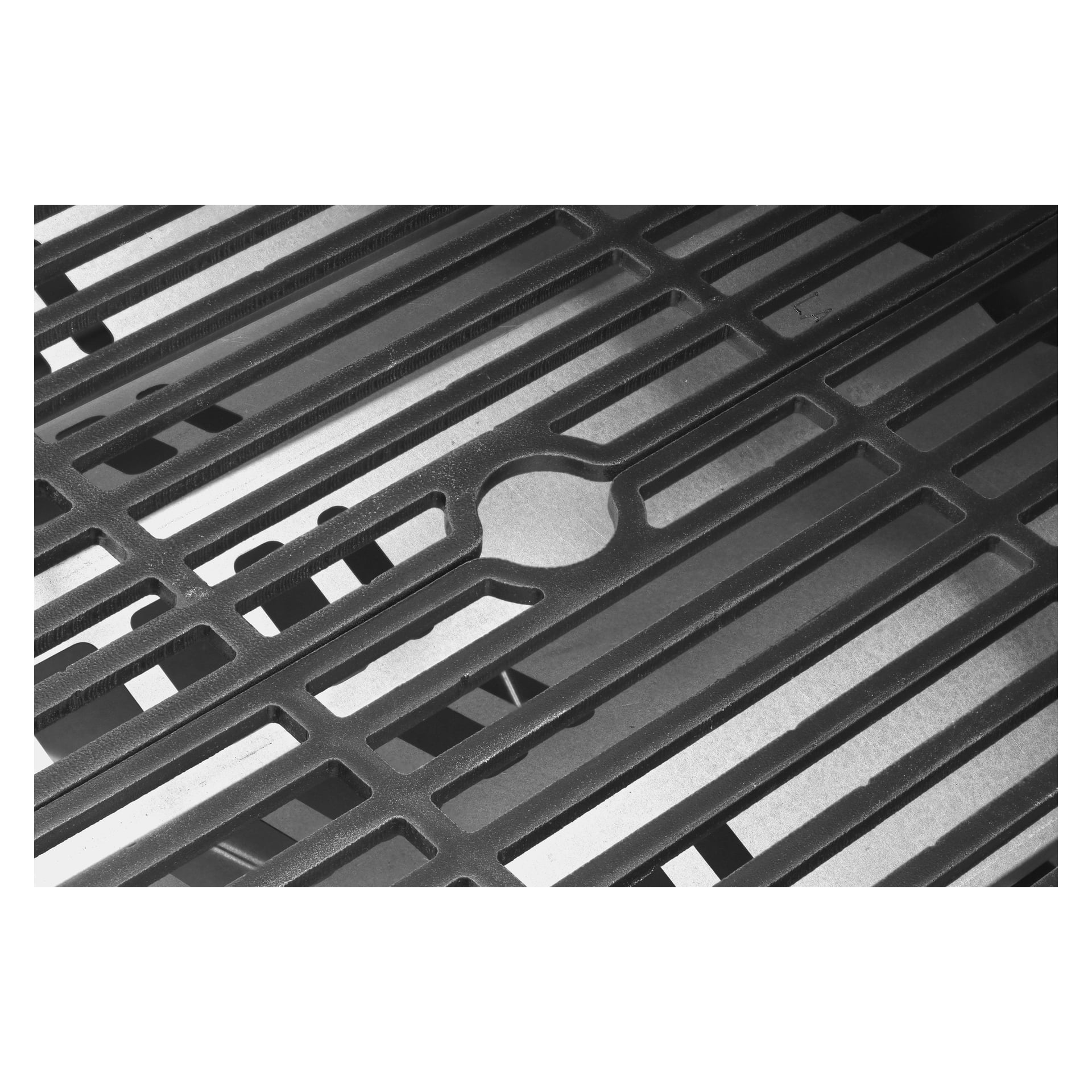 Närbild av Steely King 6342B gasgrillgallret av Burns & Barkles med rektangulära spår och en central rund utskärning. Distinkta skuggor framhäver metallgallrets unika mönster och struktur i gråskala.