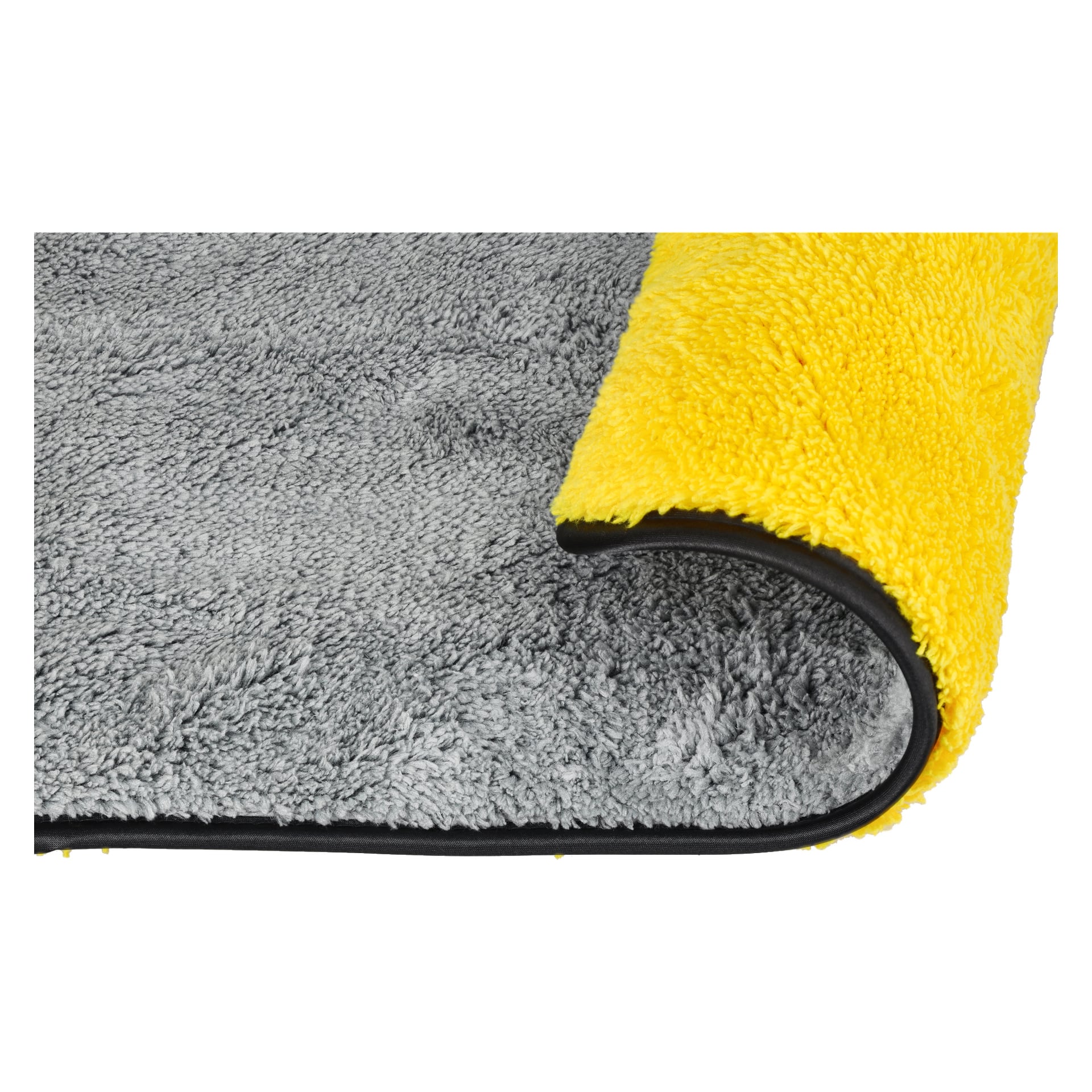 En detaljerad vy av Hamron Microfibre-tyget visar dess dubbla sidor—en grå, en gul—där tyget delvis är rullat för att avslöja båda färgerna och en mjuk textur. Kanterna är prydligt kantade med svarta lister.