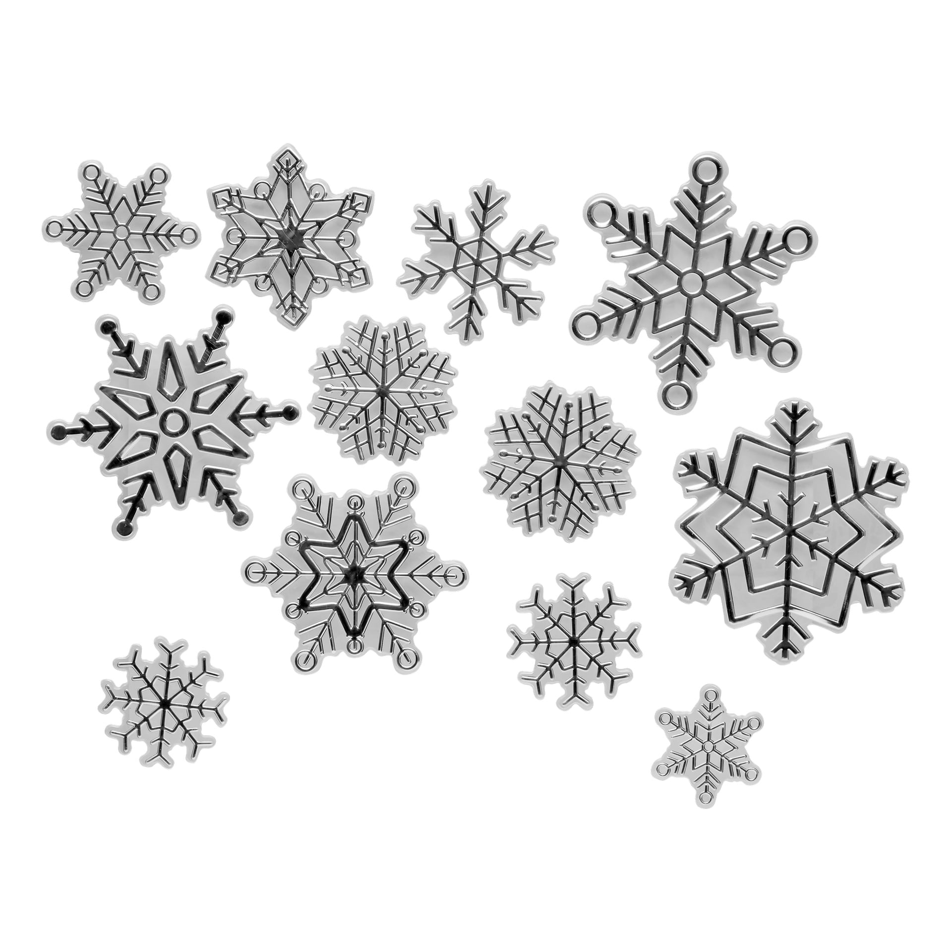 Tolv svartvita EKVIP-fönsterklistermärken med julsnöflingor i olika storlekar och geometriska mönster är tätt arrangerade tillsammans.