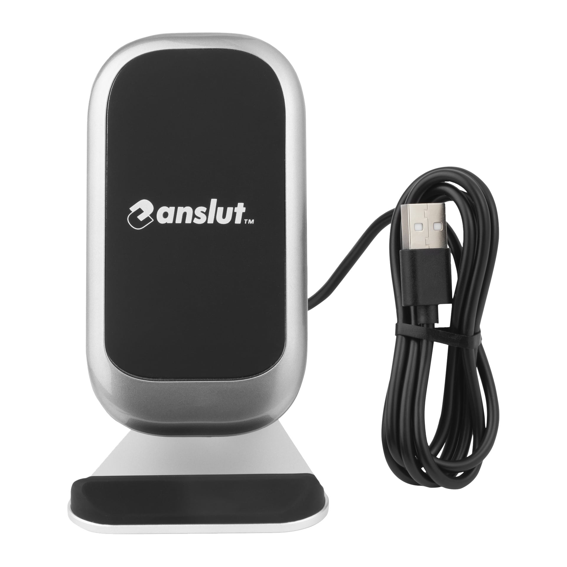 En svart og sølvfarget Anslut trådløs lader med stativ sitter ved siden av en sammenrullet USB-kabel. Laderen er rektangulær med avrundede hjørner og har et glatt svart frontpanel.