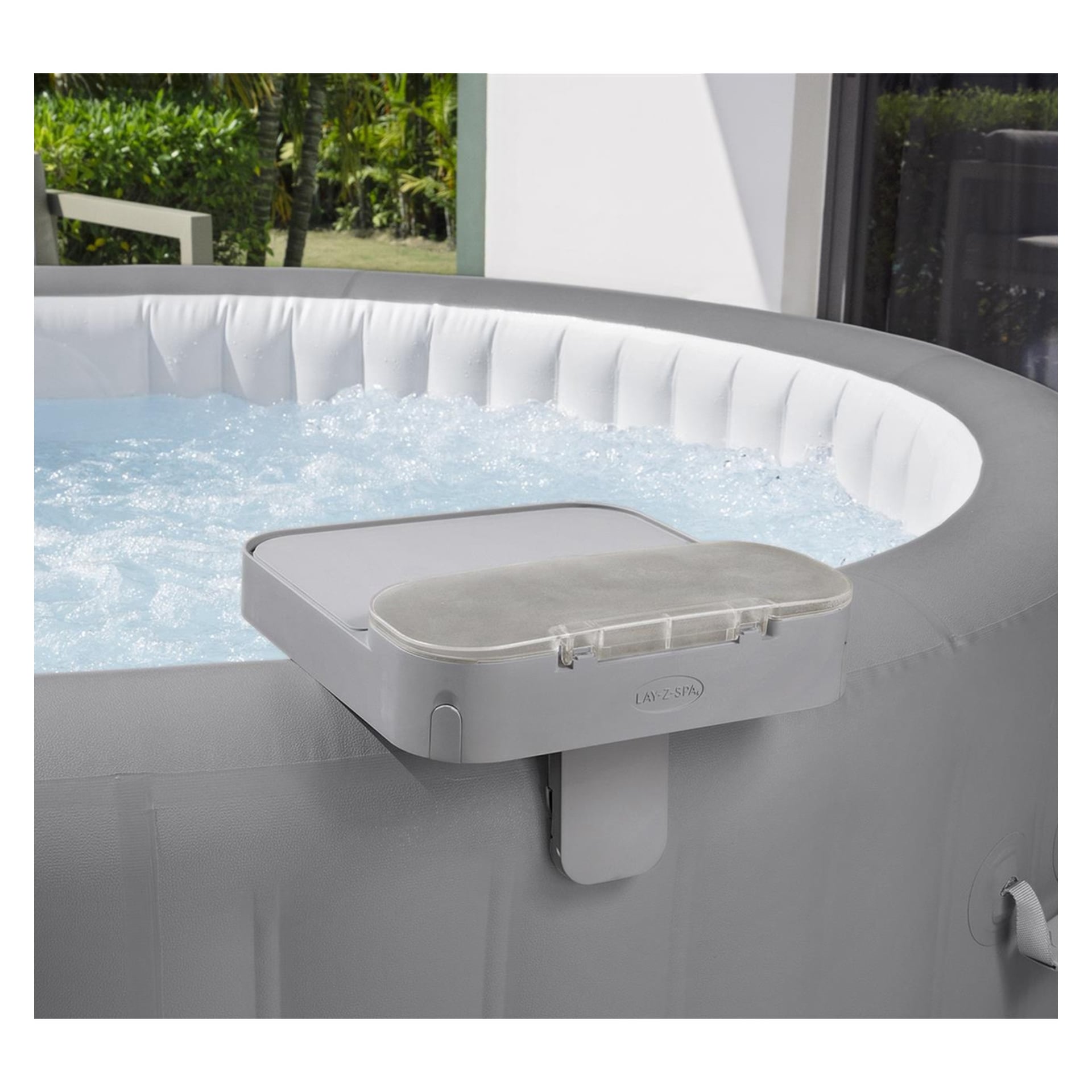 Zbliżenie szarej dmuchanej wanny spa Bestway 4-w-1 z bulgoczącą wodą, białą tacą i przezroczystą osłoną, przy oknie wychodzącym na zieleń.