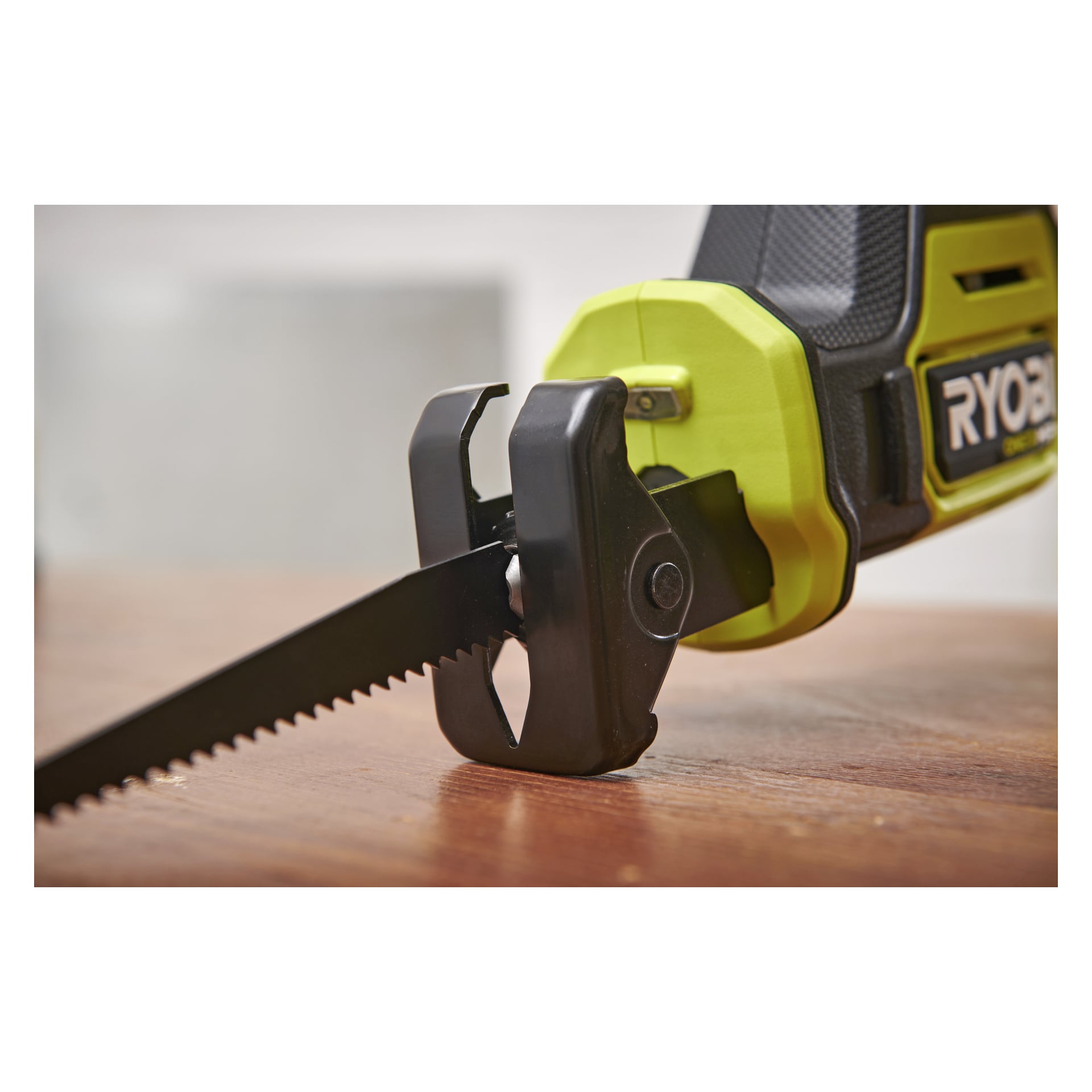 Ryobi One+ HP batteridriven bajonsåg RRS18C1, svart blad och grön/svart handtag, på en träyta.