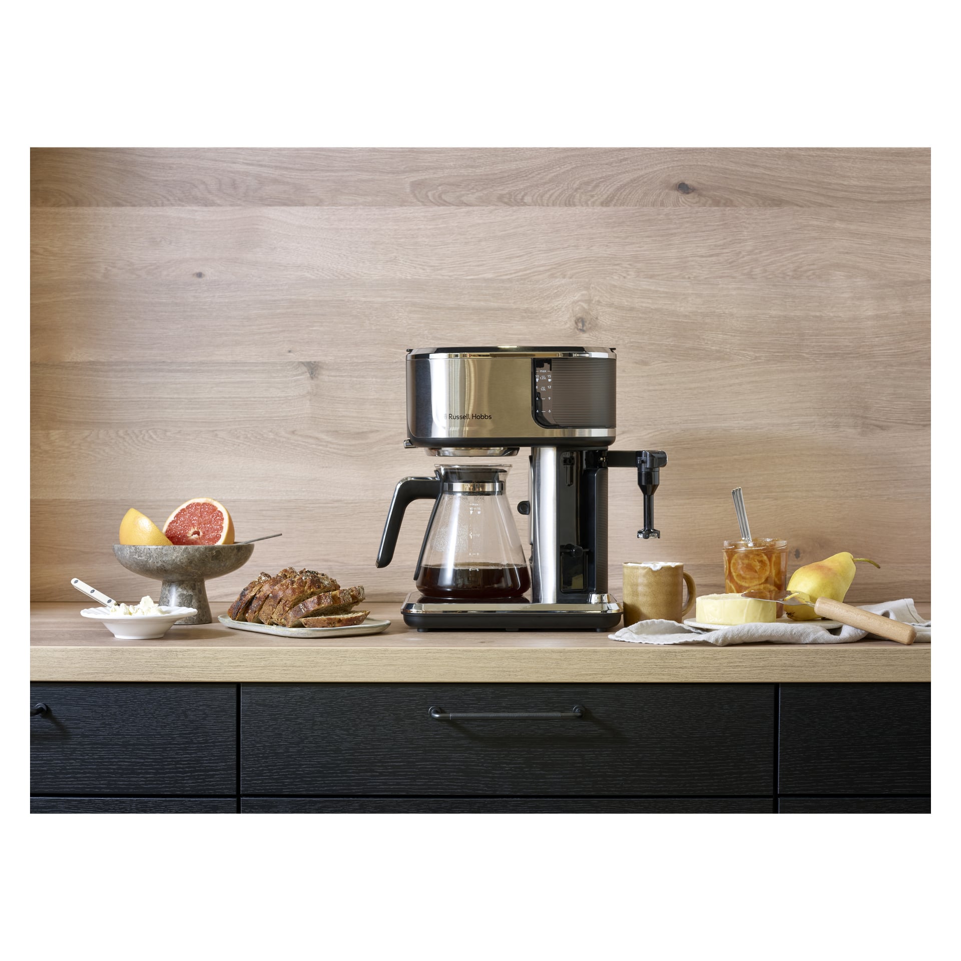 Ekspres do kawy Russell Hobbs Attentiv na drewnianym blacie z plasterkami chleba, grejpfruta, miodu, konfiturami, masłem i wałkiem do kawałka.