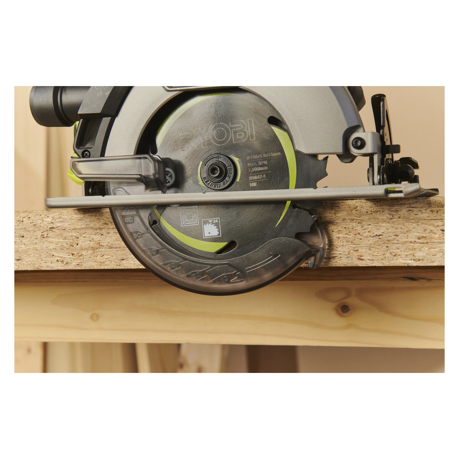 Nærbilde av Ryobi One+ HP sirkelsag RCS18X1-0 som skjærer sponplate, blad midt gjennom treoverflaten.
