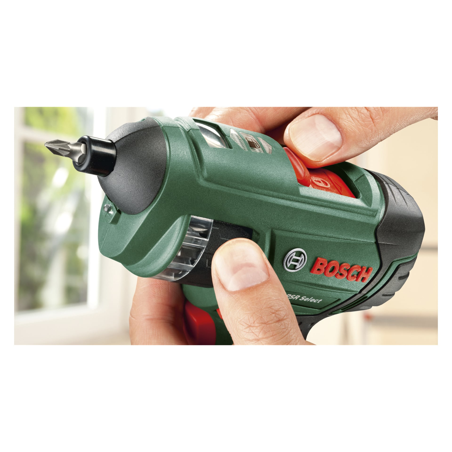 Händerna håller en Bosch PSR SELECT-skruvmejsel med laddare och Phillips-huvudbit, Bosch-varumärkets logotyp synlig på sidan.