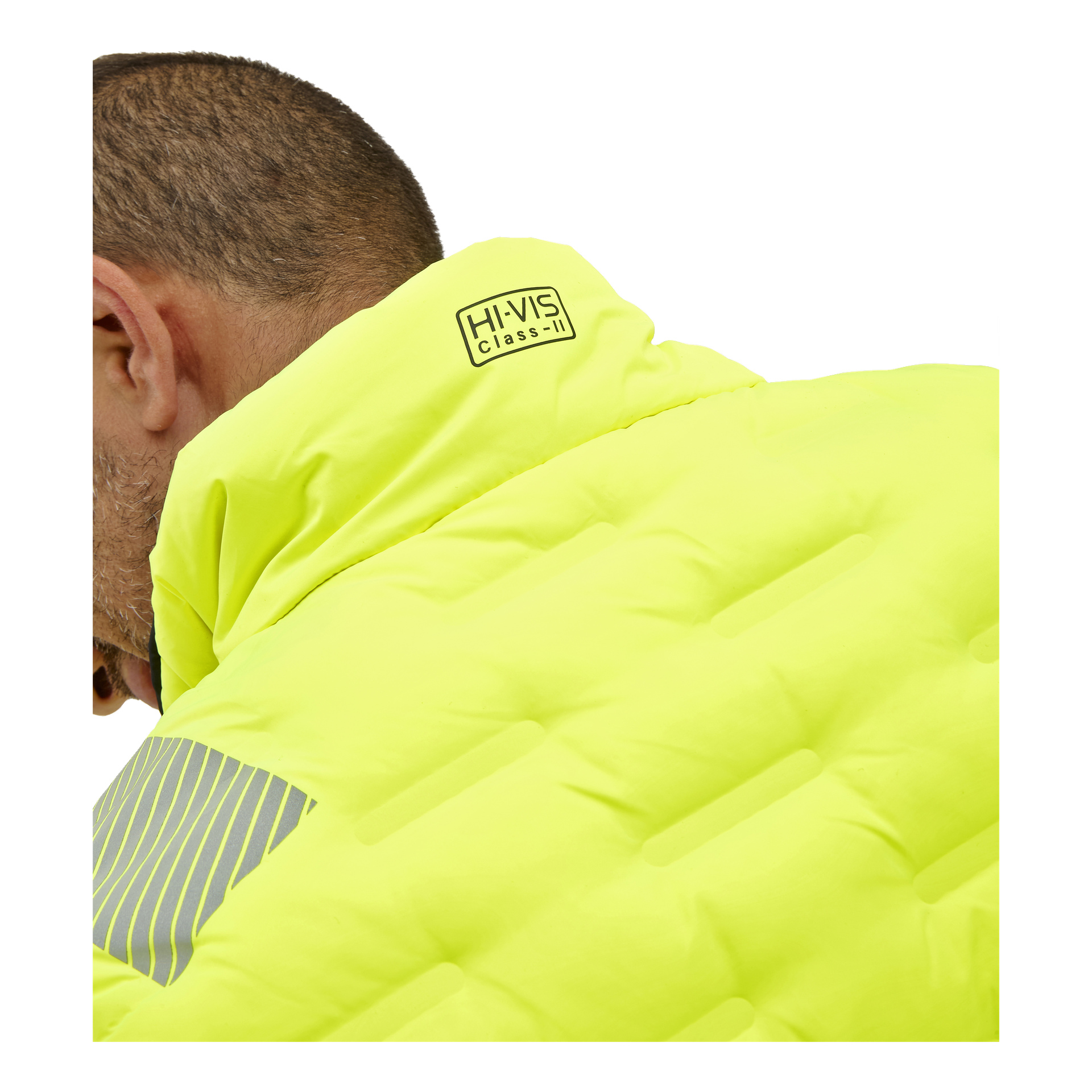 En person som bär en klargul Bluewear Warm-fodrad reversibel högsynlig väst med en reflekterande grå axelrand; endast baksidan och sidan av deras huvud syns.