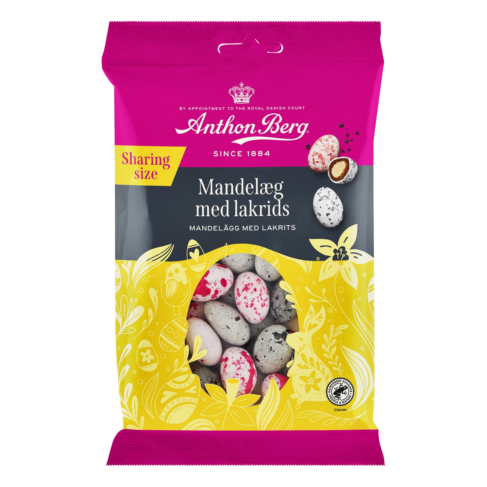 Anthon Berg mandelägg med lakrits i en rosa och gul blommig påse, fönstret visar rosa, vita och gråspräckliga godisar.