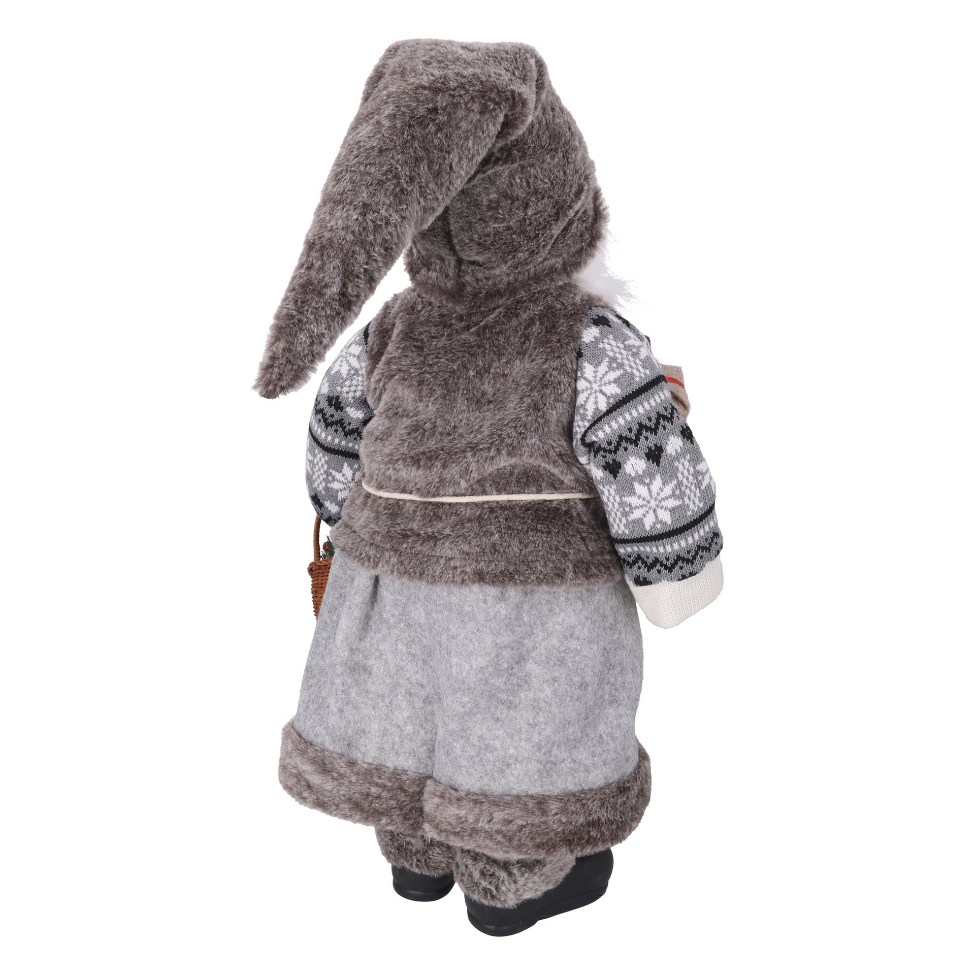 En mjuk docka i grå och brun vinterklädsel med spetsig hatt, mönstrad tröja, fluffig väst, vida byxor, korg i handen, sedd bakifrån.