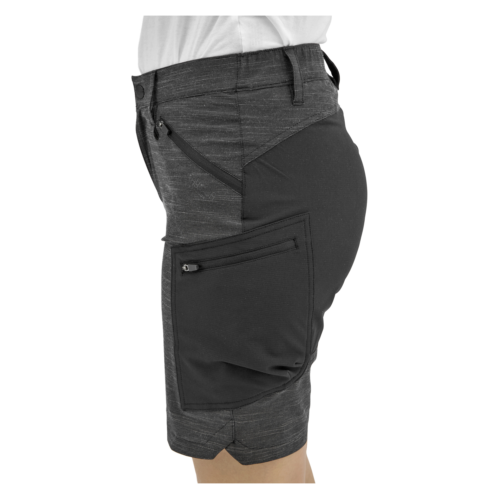 Man bär åtsittande mörkgrå shorts med en sidoficka med dragkedja, tillsammans med en vit skjorta prydligt instoppad i midjan.