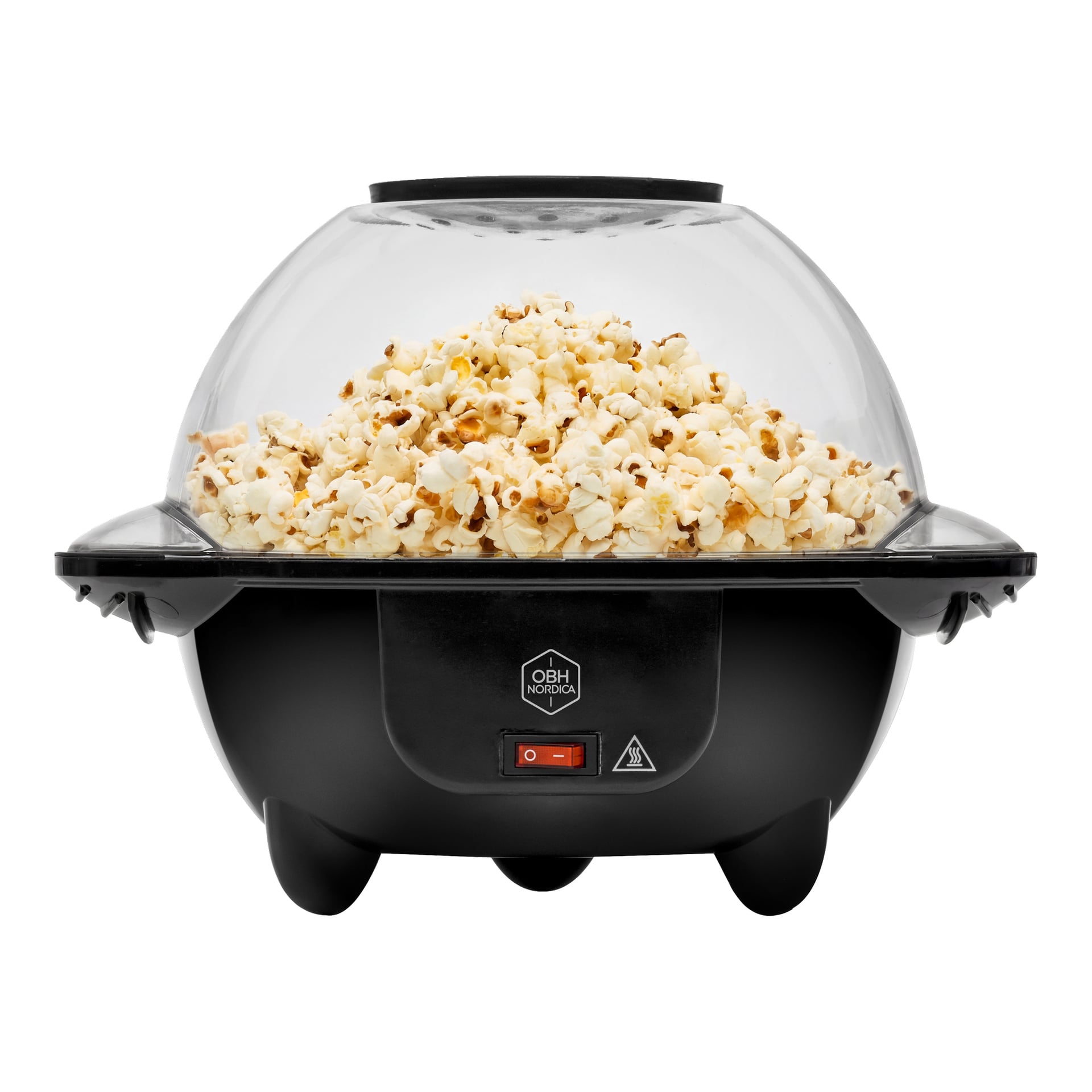 En svart elektrisk popcornmaskin med genomskinlig kupollock och röd strömbrytare, fylld med färsk popcorn.