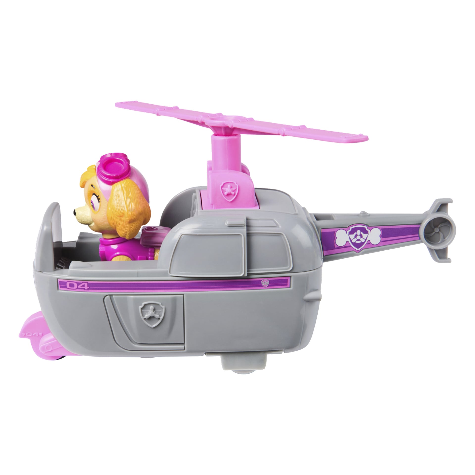 Paw Patrol Skye -leikkihelikopteri, jossa on harmaa ja vaaleanpunainen värimaailma, jossa koirahahmo Skye istuu kypärässä. Helikopteri on koristeltu tarroilla, joissa on tassunjälkiä ja numeroita, ja sen päällä on potkuri.