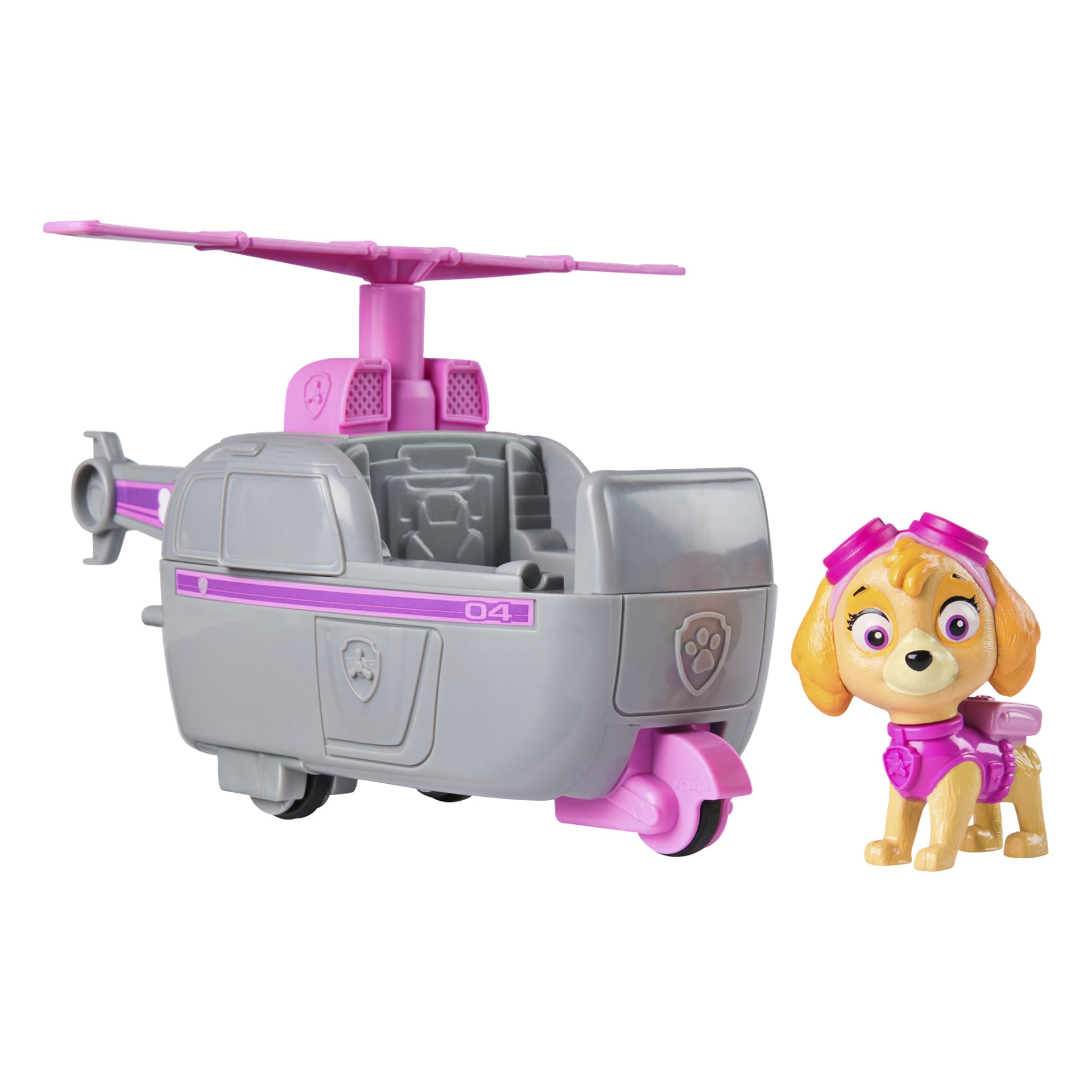 Harmaa ja vaaleanpunainen Paw Patrol -leikkihelikopteri, jossa on "04"-etiketti ja tassunjälkisymboli, istuu pienen Skye-koirahahmon vieressä, joka on pukeutunut vaaleanpunaisiin suojalaseihin ja kaulapantaan. Molemmat esineet kuuluvat Paw Patrol -leikkisarjaan lapsille.