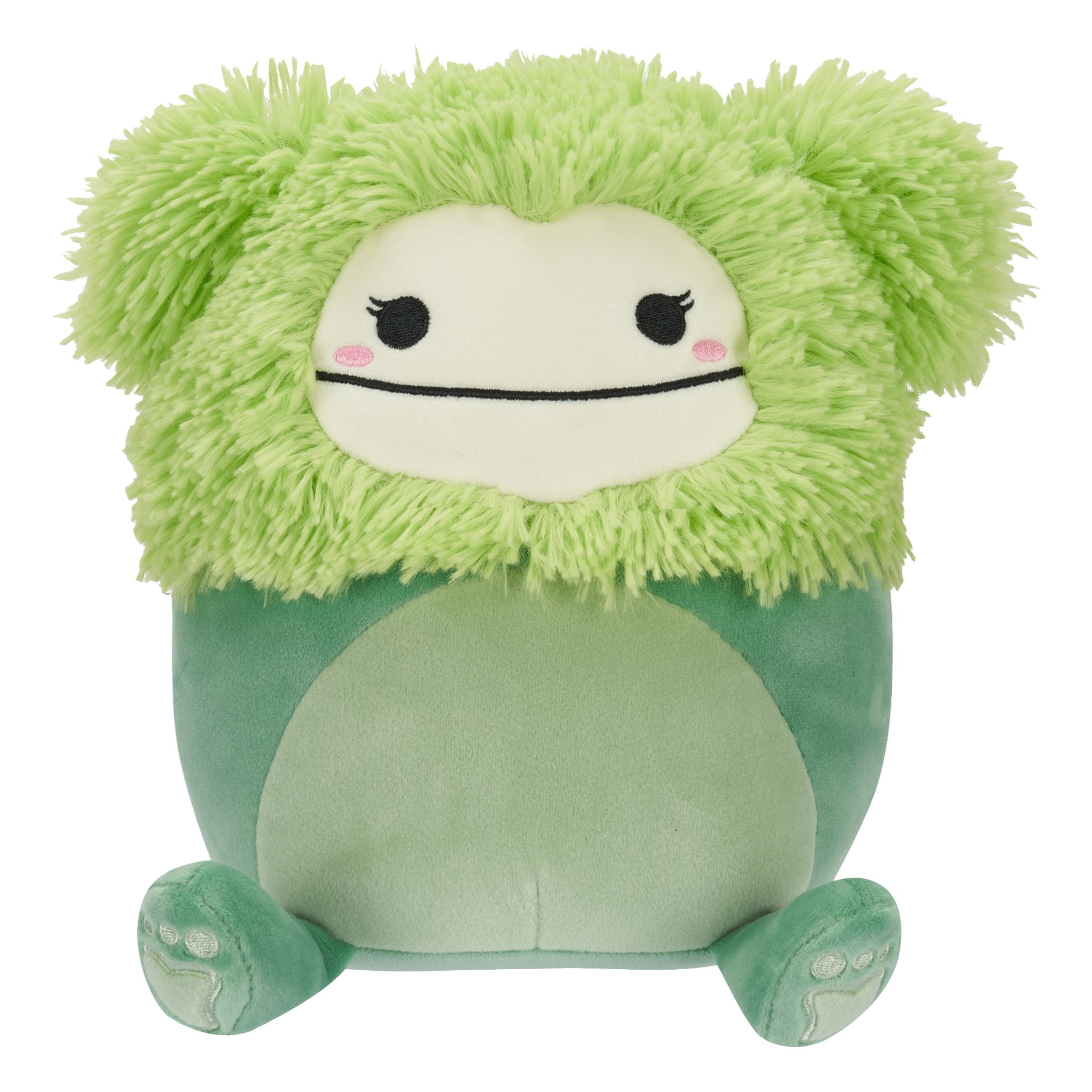 Superpehmeä Squishmallows-pehmolelu, jolla on vihreä karvainen pää, pyöreät mustat silmät, suora musta suu, vaaleanpunaiset posket ja sileä vihreä vartalo, jossa on kaksi pientä jalkaa ja jalkat, istuu pystyssä.