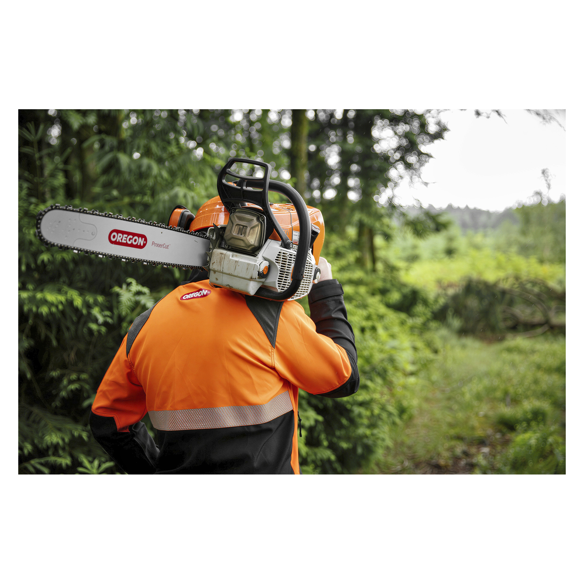 En person som bär en Protect Plus-skyddsjacka bär en motorsåg från Oregon på axeln.