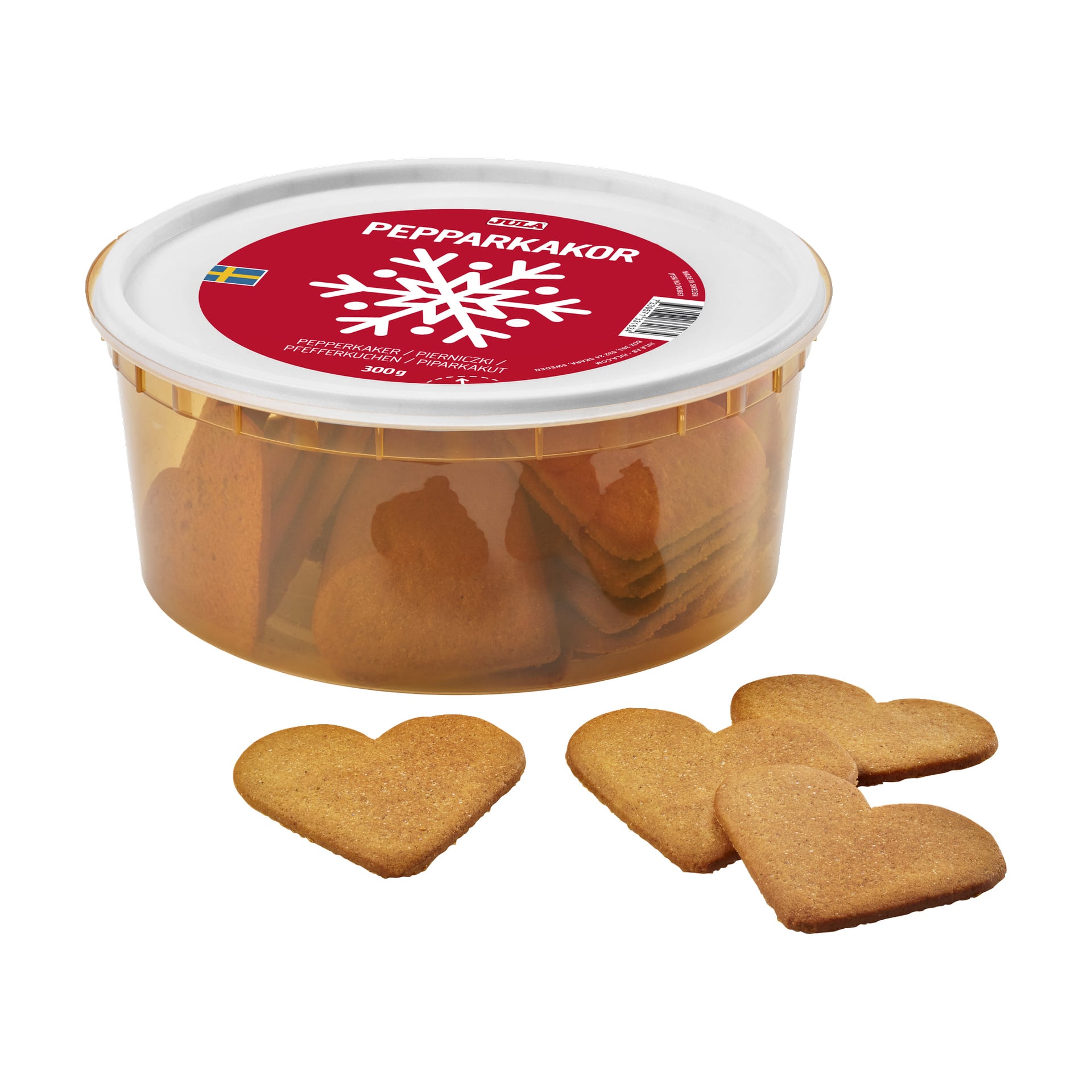 En rund plastboks med rød etikett inneholder hjerteformede brune pepperkakekaker. Tre kjeks er plassert foran beholderen. Etiketten viser "Jula PEPPARKAKOR" sammen med en hvit snøfnugg-grafikk.