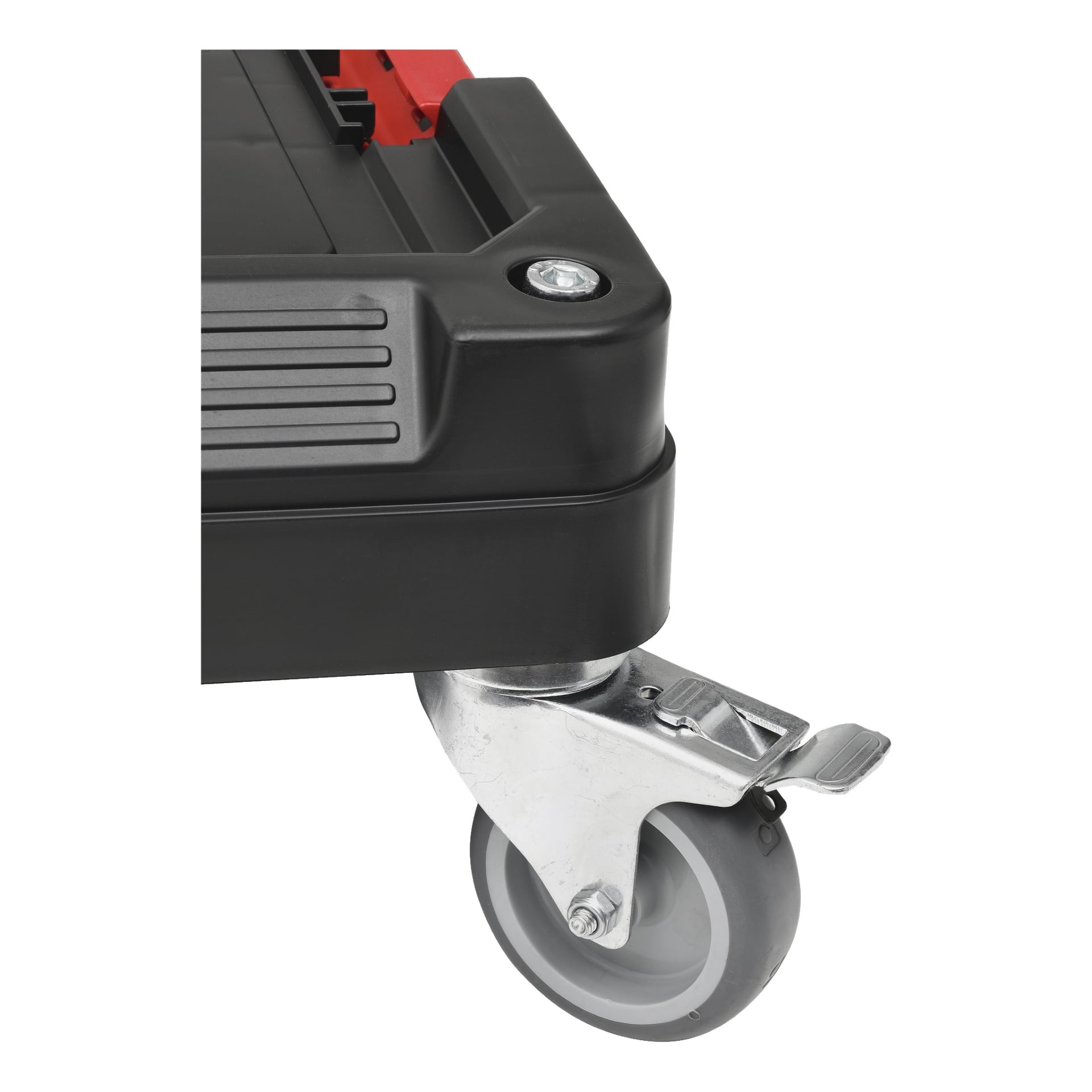 Närbild av ett grått svänghjul med en metallbroms fäst i det nedre hörnet av ett svart plast Meec Tools Transport Dolly Module-Box System. Dollyn har en synlig skruv och tydliga plastdetaljer.