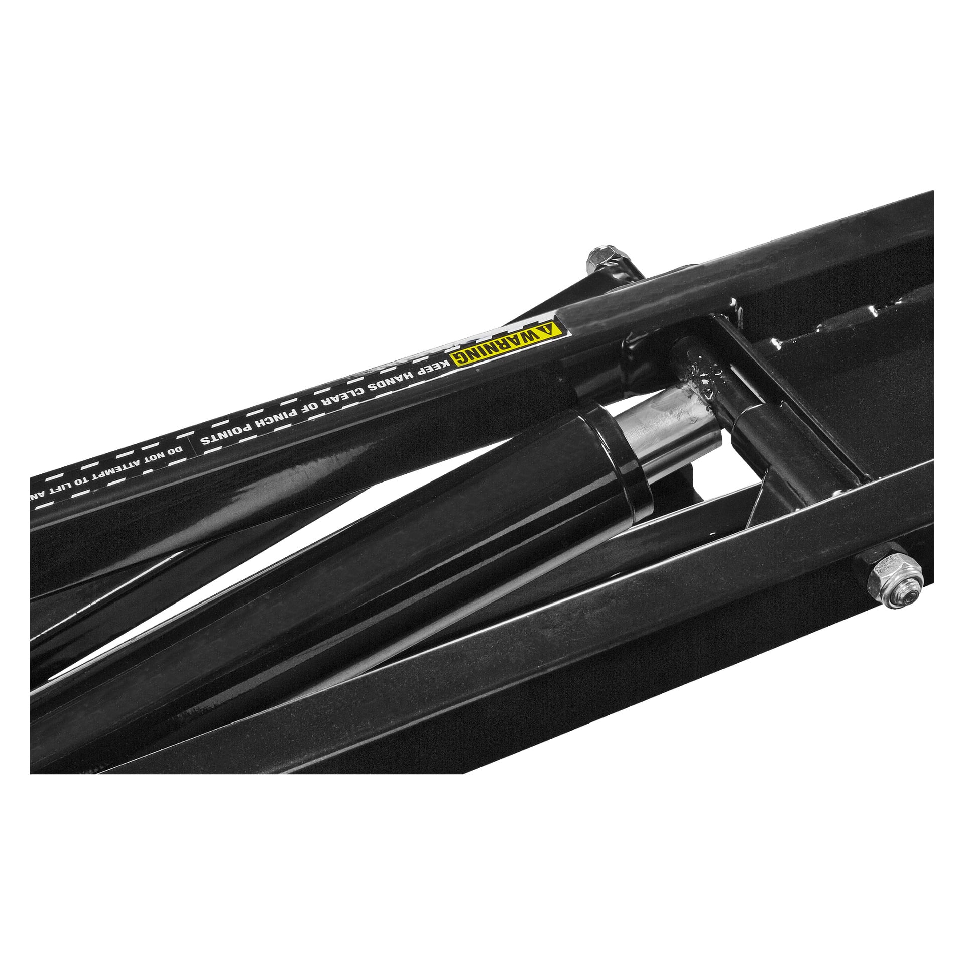 Detaljerad vy av en svart metallhydraulmekanism på Hamron Portable-billyften, som visar kolven och bultarna. En gul varningsetikett varnar användare för att hålla händerna borta från nyppunkter.