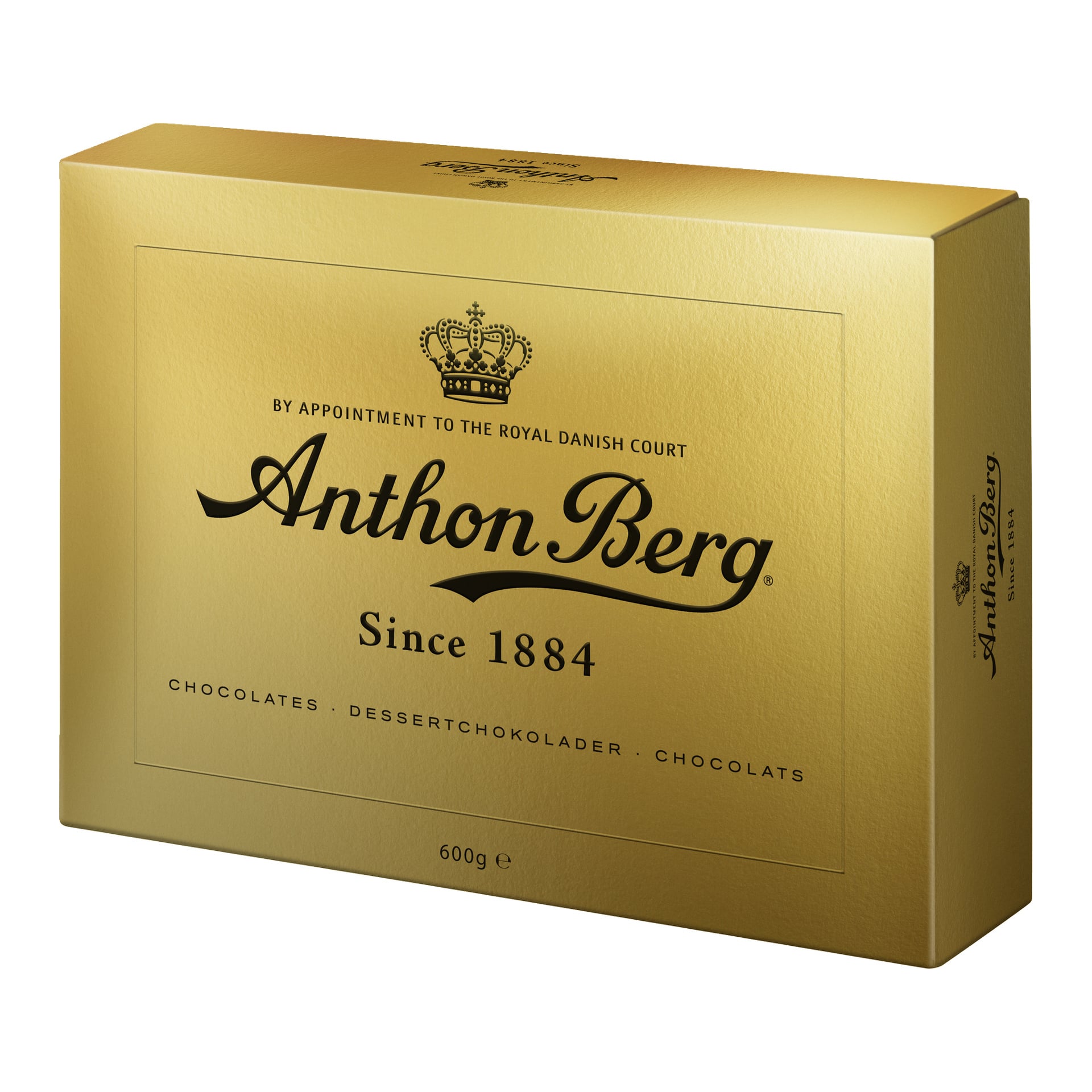 En gyllene Anthon Berg-chokladask med svart text där det står By appointment to the Royal Danish Court, Since 1884, 600g. Förpackningen har en krona och visar ordet choklad på tre olika sätt.