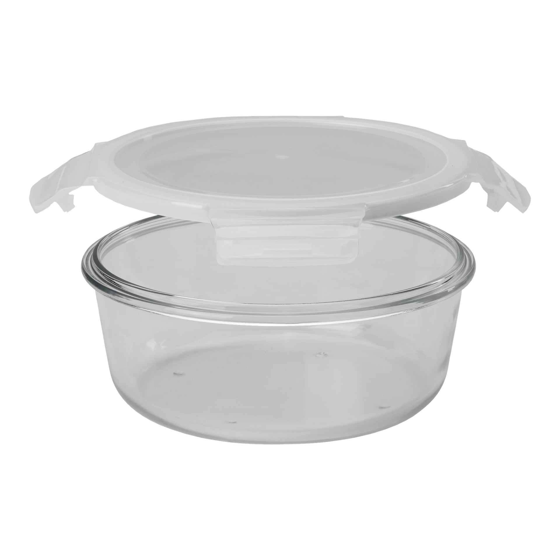 En Menuett Food Box står med sin genomskinliga, runda glasbas och ett vitt plastlock som är fäst och delvis öppet för att visa det tomma insidan.