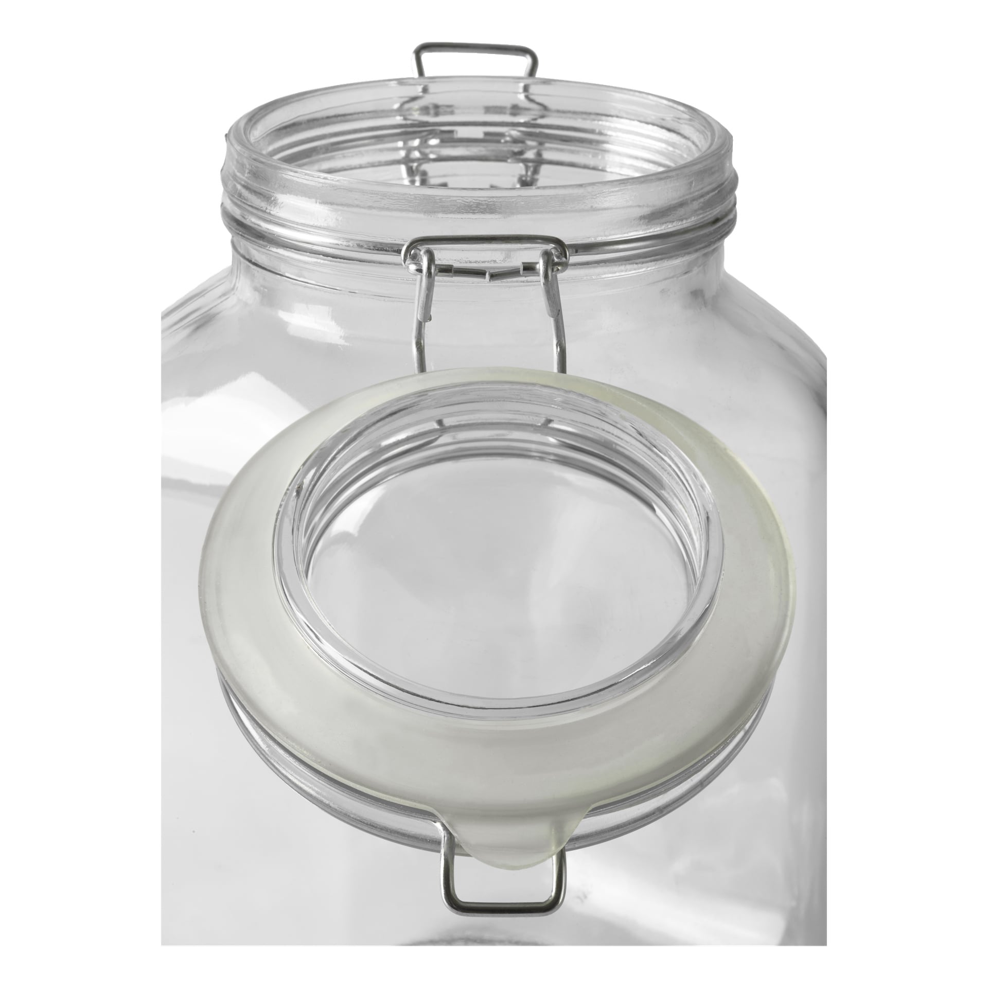 En närbild av Menuett Glass Jar med en svängpropp, som visar dess transparenta glaskonstruktion, öppet gångjärnslock säkrat med ett metallspänne, och en vit packning som kantar för en lufttät tätning. Burken visas tom.