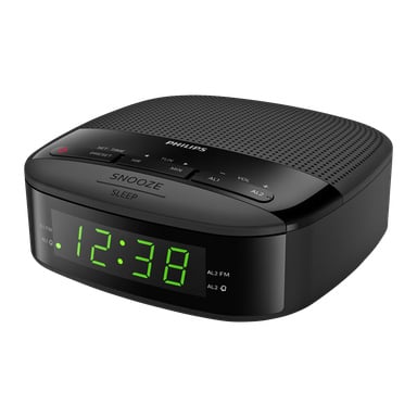 En svart Philips TAR3205 klockradio visar klockan 12:38 med gröna digitala siffror. Toppen har knappar för snooze, viloläge, tid och alarm, samt volym- och radiokontroller. Den har en kompakt, rundad form.