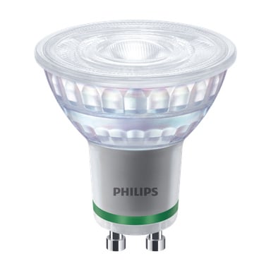 En Philips GU10 reflektor LED-lampa med en klar, fasetterad lins, en silverfärgad bas accentuerad av en grön rand nära botten, och märket "Philips" tryckt på basen.