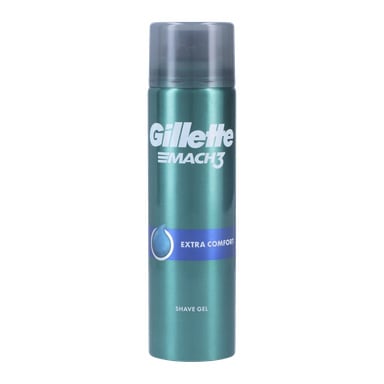 En burk Gillette Shaving Gel Mach3 Extra Comfort med tealfärgad kropp, blå etikett och grå mössa. Framsidan visar Gillette-logotypen och produktinformation i vita bokstäver.