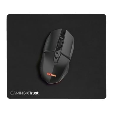 Eine schwarze Trust Gaming GXT 112 FELOX kabellose Maus mit leuchtendem Logo sitzt auf einer großen schwarzen GAMING X Trust Mausmatte, beide von oben vor neutralem Hintergrund betrachtet.