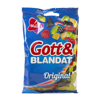 En blå Malaco Gott & Blandat Original-påse har en mängd färgglada gelégodisar på framsidan, med Malaco-loggan uppe i vänstra hörnet.