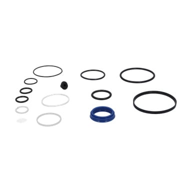 En packningsdomkraft med en blandning av cirkulära gummi- och plast-O-ringar och packningar i olika storlekar och färger – svart, vit och blå – arrangerade separat.