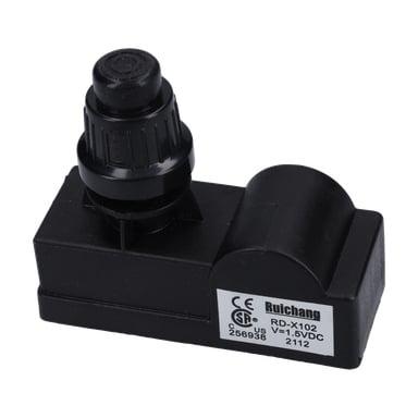 En svart Ruichang tändmodul F. 016963 med RD-X102, 1,5 VDC-etikett, certifieringsmärken och en cylindrisk kontakt ovanpå.