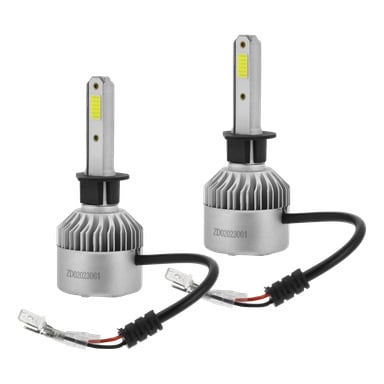 Ett par Hamron H1 LED-billampor visas bredvid varandra, båda med ett slankt silverhölje, svarta kablar och kontakter samt ett gult rektangulärt område högst upp. Bilden visar hela uppsättningen av två lampor.