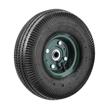 Ett Hamron uppblåsbart gummihjul med svart, räfflat mönster och ett grönt metallnav som visade flera hål och en synlig ventilstam. Däcket visar frasen "EJ FÖR VÄGBRUK.".