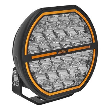 Hamron Extra LED to okrągłe światło do jazdy z czarną obudową, segmentowaną przezroczystą szybą, bursztynową lamówką, metalowym uchwytem i przednim logo.