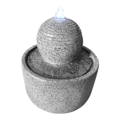 Hard Head Fountain med LED-belysning er et lite, rundt vannanlegg laget av grå stein som har en teksturert kule. Vannet renner fra toppen av kulen og fosser mykt ned i et sirkulært basseng under.