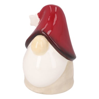 Sidovy av en beige keramisk figur med vit mage och hög röd spetsig hatt, ansiktet dolt förutom en stor näsa.