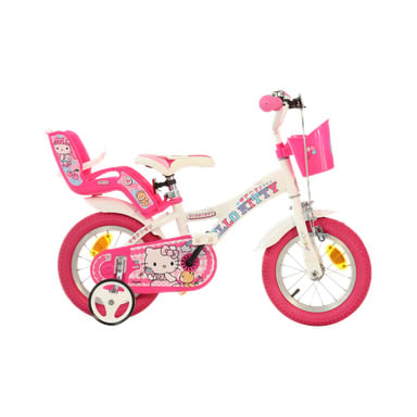 Różowo-biały rower dziecięcy z kółkami treningowymi, akcentami Hello Kitty, różowym koszykiem i tylnym siedzeniem na lalkę lub zabawkę.