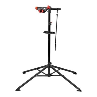 Kayoba Repair Stand mustana ja punaisena, jossa on säädettävä puristin, jalusta, integroitu työkalulokero ja kiinnityshihna polkupyörän paikallaan pitämiseen.