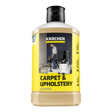 Pullo Kärcher Cleaning Aine RM 519 Carpet & Upstery Cleaneria, jossa on keltainen etiketti ja kuva henkilöstä, joka käyttää imuria. Etiketti korostaa etuja, kuten syväkuitupuhdistusta, tuoretta koostumusta, tasapainoista jäämää ja nopeaa kuivumista.